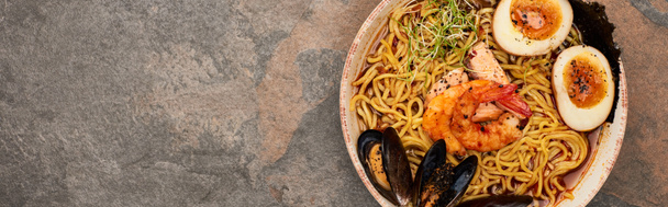top view of spicy seafood ramen on stone surface, panoramic shot - Fotografie, Obrázek