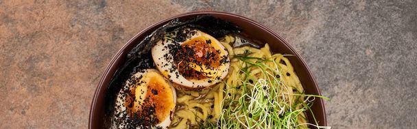 top view of spicy ramen with egg on stone surface, panoramic shot - Φωτογραφία, εικόνα