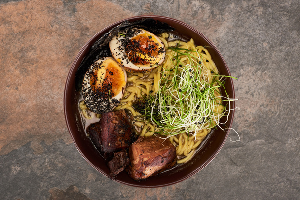 top view of spicy meat ramen on stone surface - 写真・画像