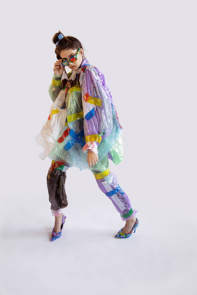 Woman addicted of sales and clothes, wearing plastic, recycling concept - Foto, imagen