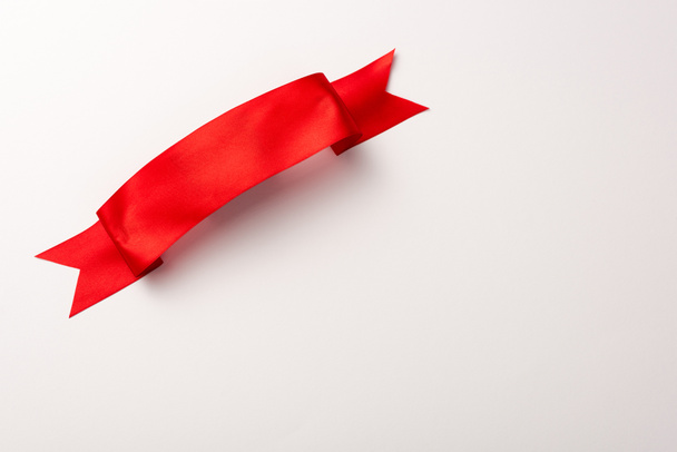 top view of red satin ribbon on white  - Zdjęcie, obraz