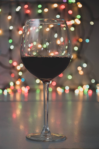 wineglass with sparkling wine on garland background - Photo, Image