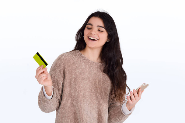 Woman with credit card and smartphone. - Zdjęcie, obraz
