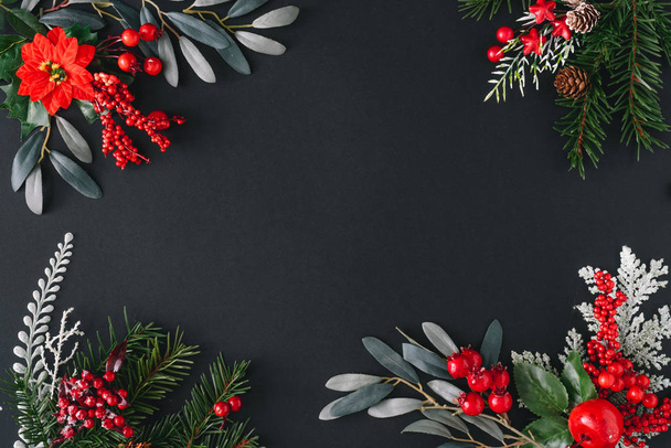 Christmas border frame made of natural winter things on dark background  - Φωτογραφία, εικόνα