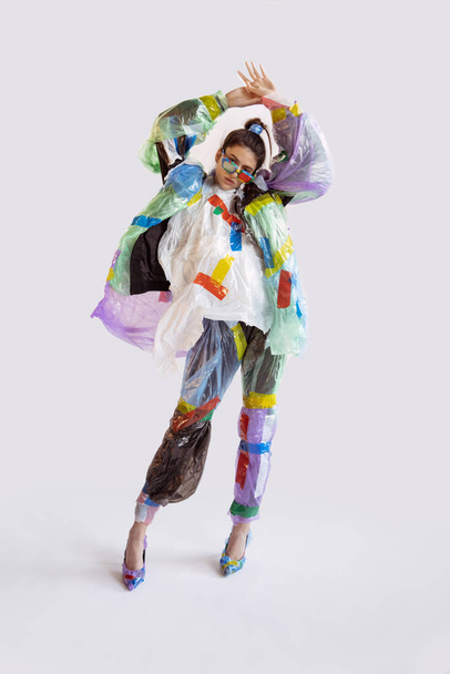 Woman addicted of sales and clothes, wearing plastic, recycling concept - Foto, Bild