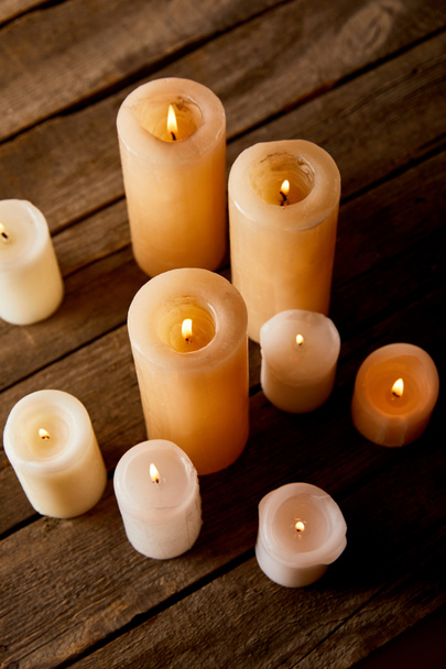 burning candles on wooden table on christmas eve - Foto, Imagem