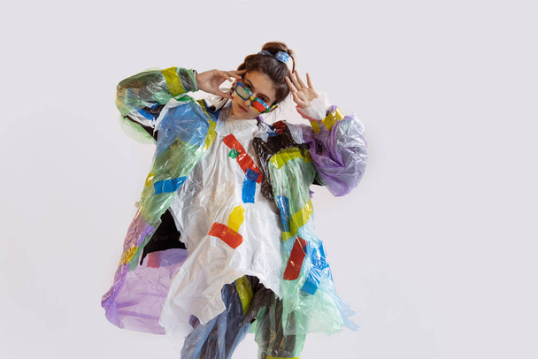 Woman addicted of sales and clothes, wearing plastic, recycling concept - Fotografie, Obrázek