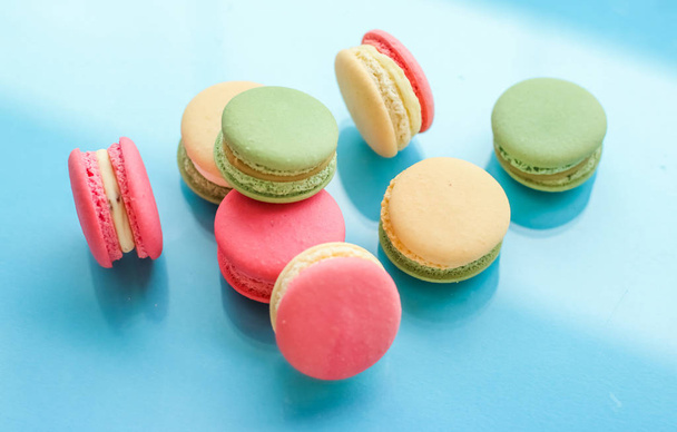 French macaroons on blue background, parisian chic cafe dessert, - 写真・画像