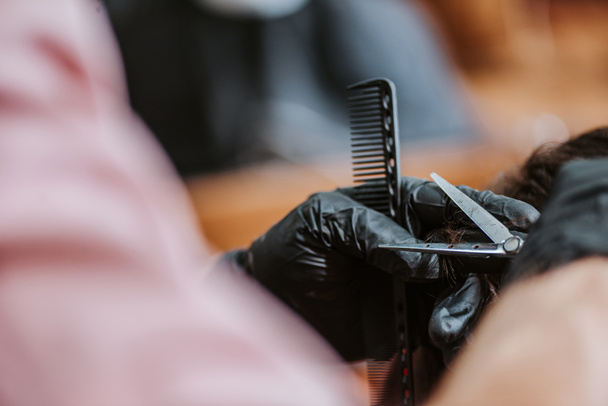 vista recortada de peluquero corte de pelo de hombre en la barbería
  - Foto, Imagen