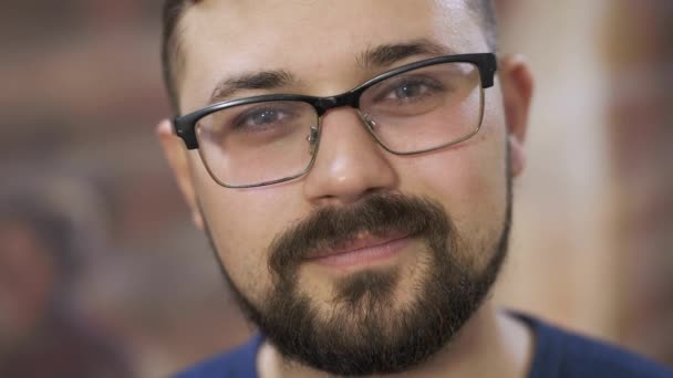 man with glasses smiles in coworking office close view - Video, Çekim