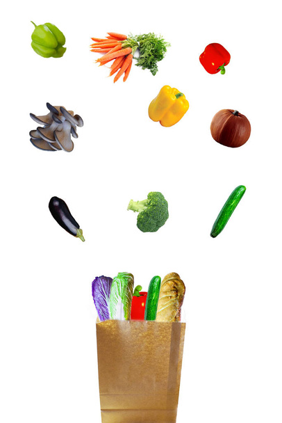 fresh vegetables fall in a paper bag - Fotó, kép