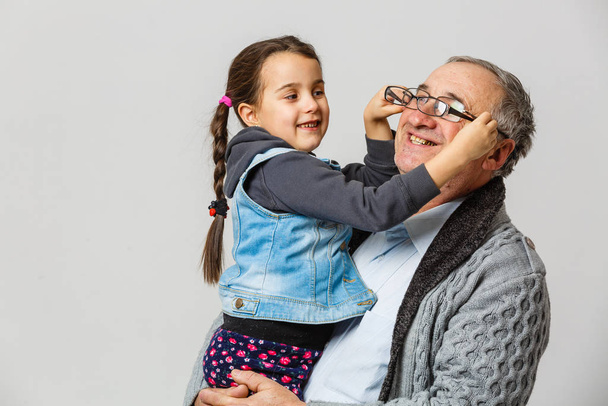 grandfather and granddaughter with glasses at home  - Photo, Image