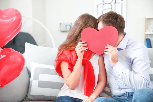Happy young couple celebrating Valentine's Day at home - Foto, imagen