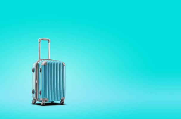 Blue suitcase is standing against turquoise background. A realistic shadow is drawn in under it. Collage. Copy space, close-up. - Fotoğraf, Görsel