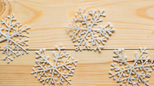 White snowflakes on wooden background. Merry Christmas concept - Fotografie, Obrázek