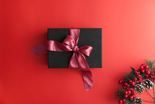 Merry christmas red background with black gift box - Zdjęcie, obraz