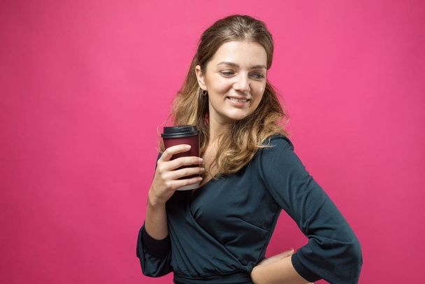 young woman with coffee cup on color background - Zdjęcie, obraz