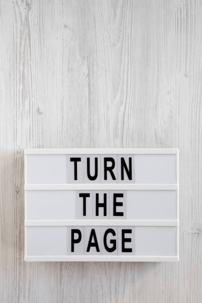 'Turn the page' words on a modern board on a white wooden surfac - Photo, Image