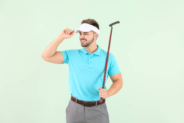 Handsome male golfer on color background - Zdjęcie, obraz