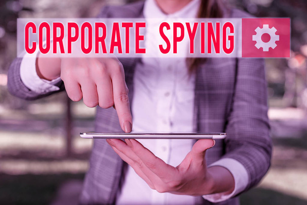 Handwriting text writing Corporate Spying. Concept meaning investigating competitors to gain a business advantage Outdoor scene with business woman holds lap top with touch screen. - Photo, Image