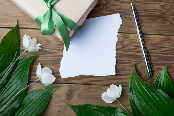 paper with flowers on a wooden background - Photo, Image