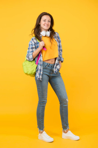 Brainy is new sexy. Happy student yellow background. University student carry backpack. Pretty student smile in casual wear. Senior high student. Girl back to school. University. Higher education - Zdjęcie, obraz