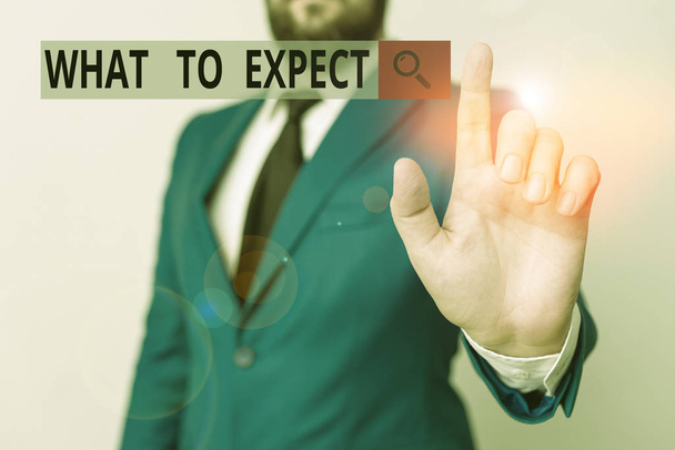 Text sign showing What To Expect. Conceptual photo Confusion about the belief of what will happen in future Businessman with pointing finger in front of him. - Foto, afbeelding