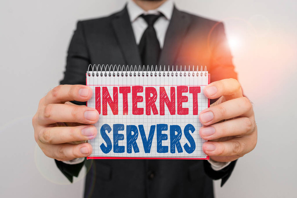 Writing note showing Internet Servers. Business photo showcasing delivers the content of the page back to the user Male human wear formal work suit with office look hold book. - Photo, Image