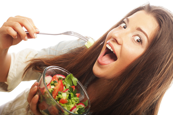Joven mujer feliz comiendo ensalada
. - Foto, imagen