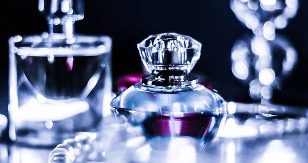 Perfume bottle and vintage fragrance on glamour vanity table at  - Foto, afbeelding
