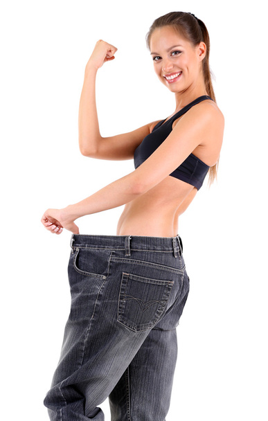Slim girl in big jeans isolated on white - Zdjęcie, obraz