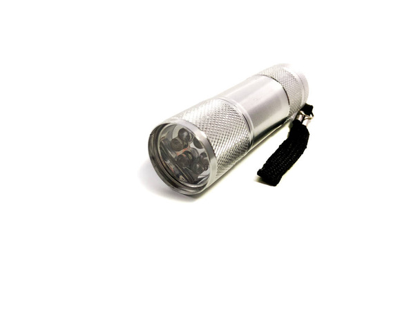 Metal flashlight isolated on a white background. A small flashlight with bulbs. - 写真・画像