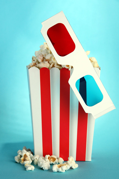 Popcorn and 3D glasses on blue background - Photo, image