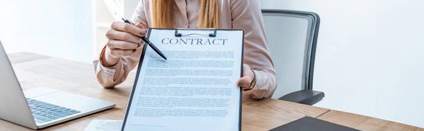 cropped view of travel agent pointing with pen at contract on clipboard - Photo, image