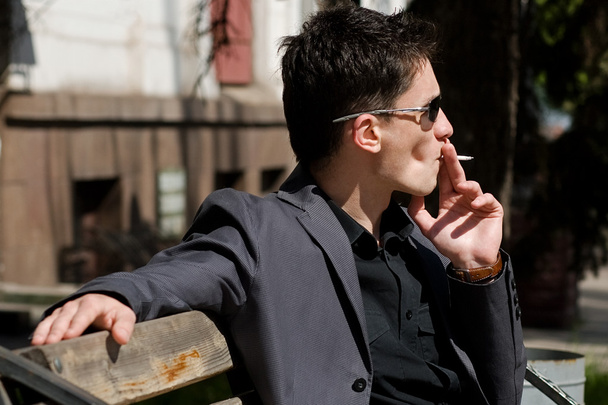 Smoking young man in sunglasses - Fotoğraf, Görsel