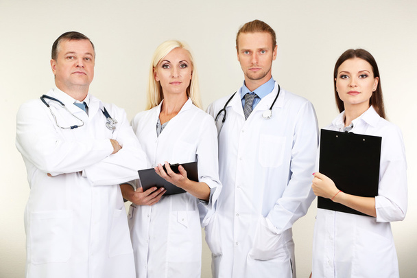 Medical workers on grey background - Φωτογραφία, εικόνα