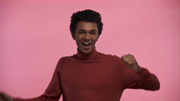 african american teenager dancing isolated on pink - Metraje, vídeo