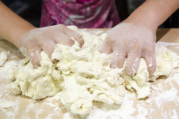 Femme pétrissant la pâte dans la cuisine - Photo, image