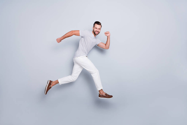 Full length body size view of his he nice attractive sportive cheerful cheery purposeful strong bearded guy running fast discount isolated over light grey pastel color background - Zdjęcie, obraz
