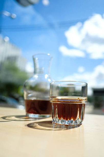 glass jar and glass with whiskey on tabletop - Foto, Bild