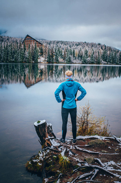 Man standing by the winter lake, sport wallpaper. - Fotó, kép