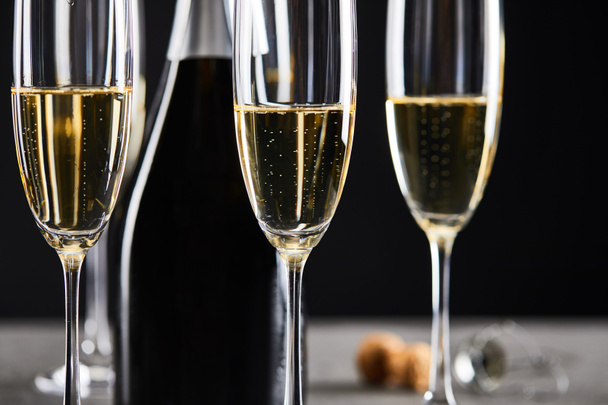 glasses and bottle of champagne for celebrating christmas on black - 写真・画像