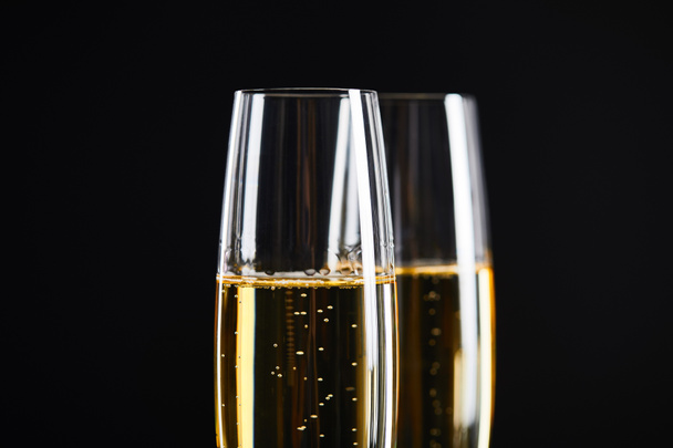close up of champagne in glasses for celebrating christmas, isolated on black  - Foto, Bild