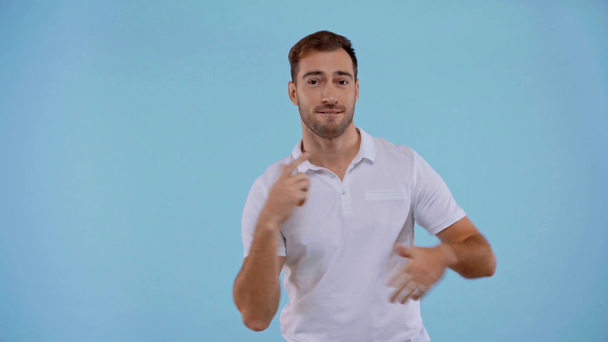 smiling man dancing isolated on blue - Footage, Video