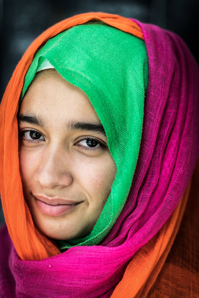 Beautiful girl with colorful scarf portrait - 写真・画像