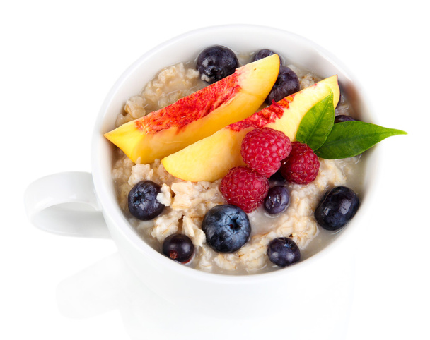 Oatmeal in cup with berries isolated on white - Photo, Image