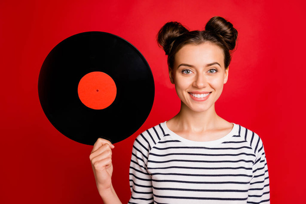 Portrait of cheerful charming girl hold retro vynil plate vintage music sound lover wear stylish white sweater isolated over red color background - Photo, Image