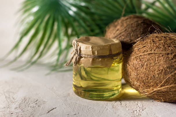 coconut and bottle of coconut palm oil. healthy food vegan aromatherapy concept - Photo, Image