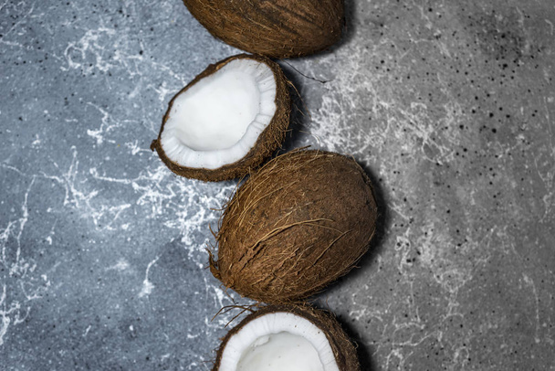 ripe chopped coconut on a gray stone background. place for your text - Foto, imagen