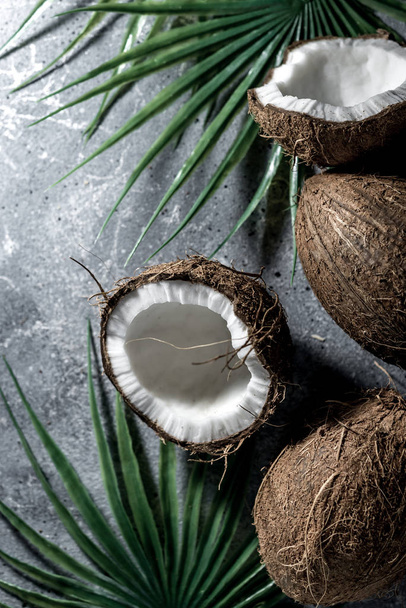 ripe chopped coconut on a gray stone background. place for your text - Foto, afbeelding